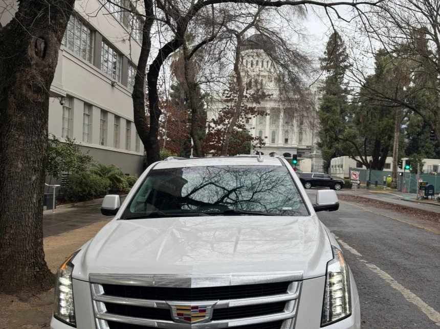 White luxury SUV with the EXEC CS plate parked at the California State Capitol in Sacramento