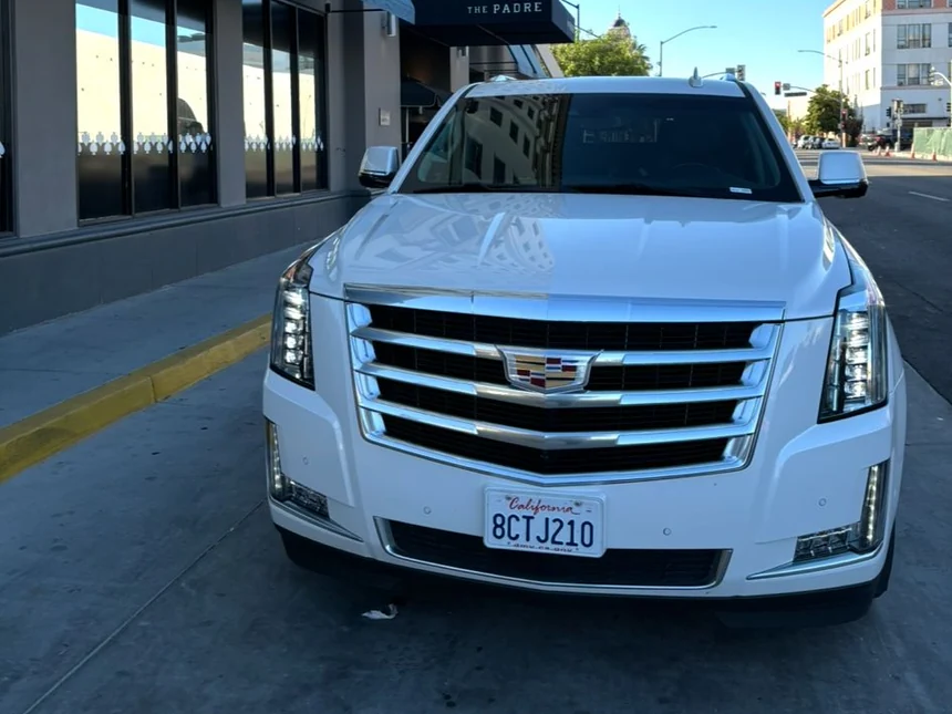 White luxury SUV waiting at the entrance of The Padre Hotel in downtown Bakersfield